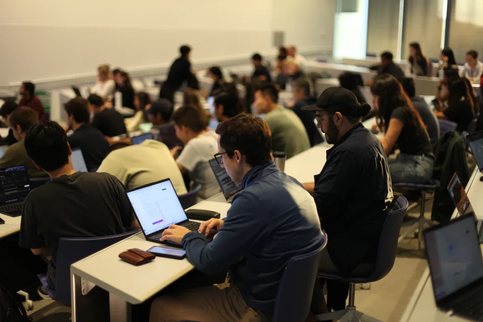 Participants working on laptops in a classroom.